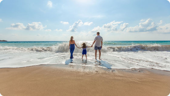 Family walking on the beach—Record your memories and preserve your legacy.